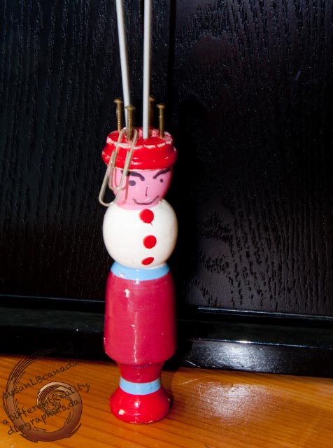 knitting Dolly holding 2 double-pointed knitting needles