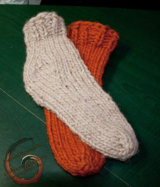 one orange wool sock and one cream