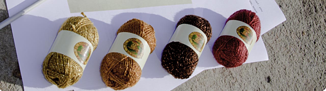 cropped image: 4 brown and orange tone mini balls of yarn