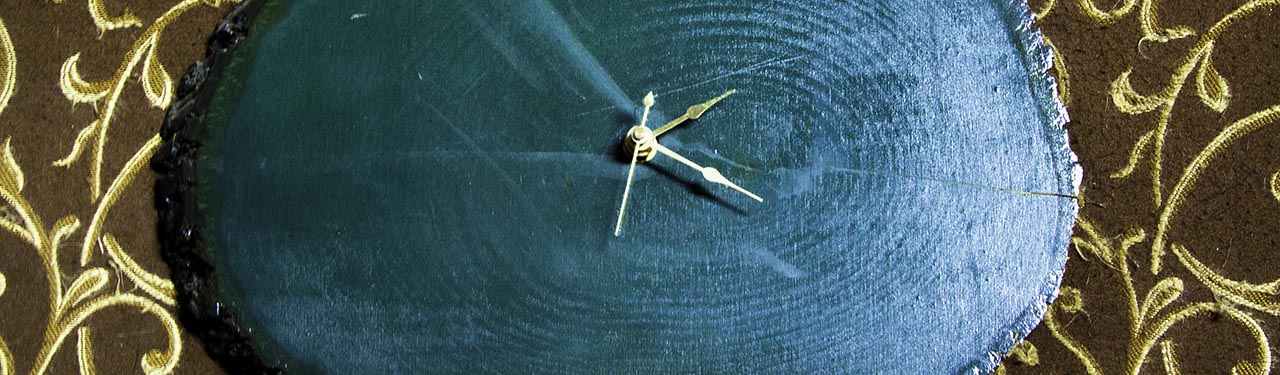 cropped image: green wooden wall clock, gold hands