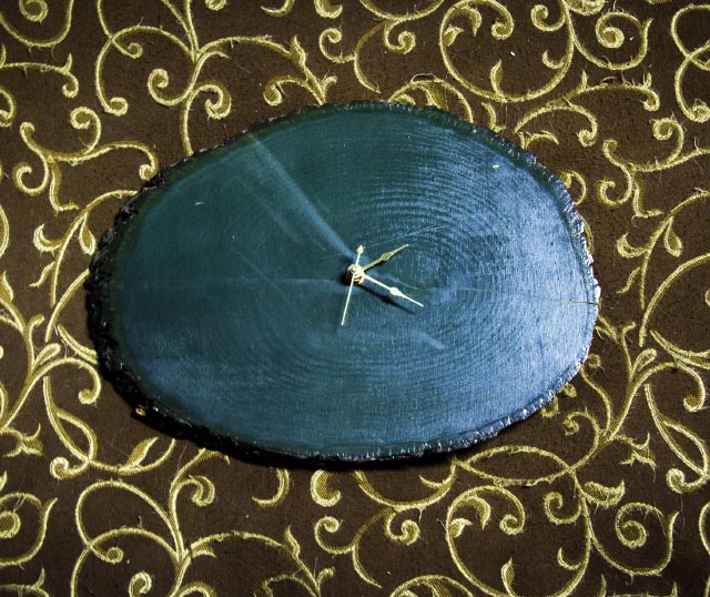 green clock with no numerals on brown and gold background