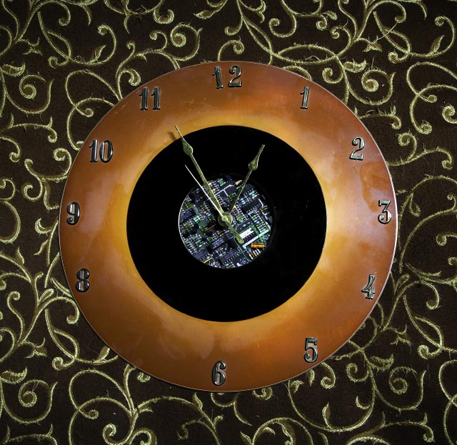 a rust coloured clock with circuit board centre, missing the 7