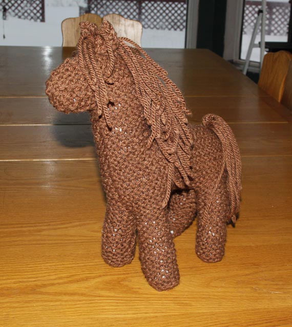 knit brown horse standing on a table