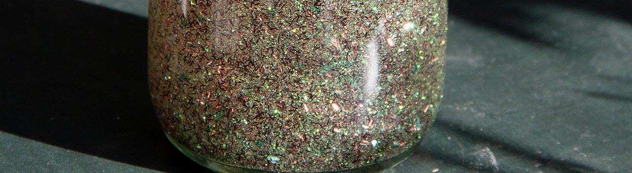 tall shiny jar of glitter in the sunlight