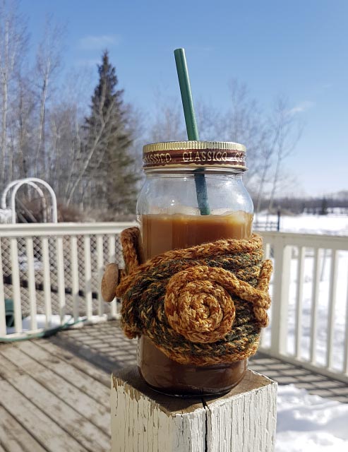 jar of iced coffee on a post with green/gold hug